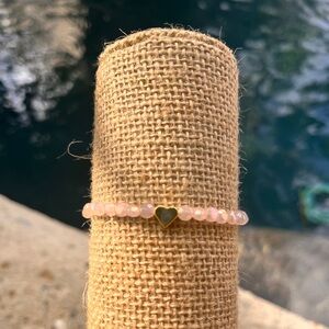 Light pink faceted beads with gold heart